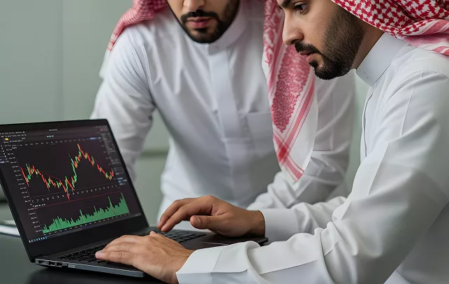 Traders Evaluating Market Movement on Laptop